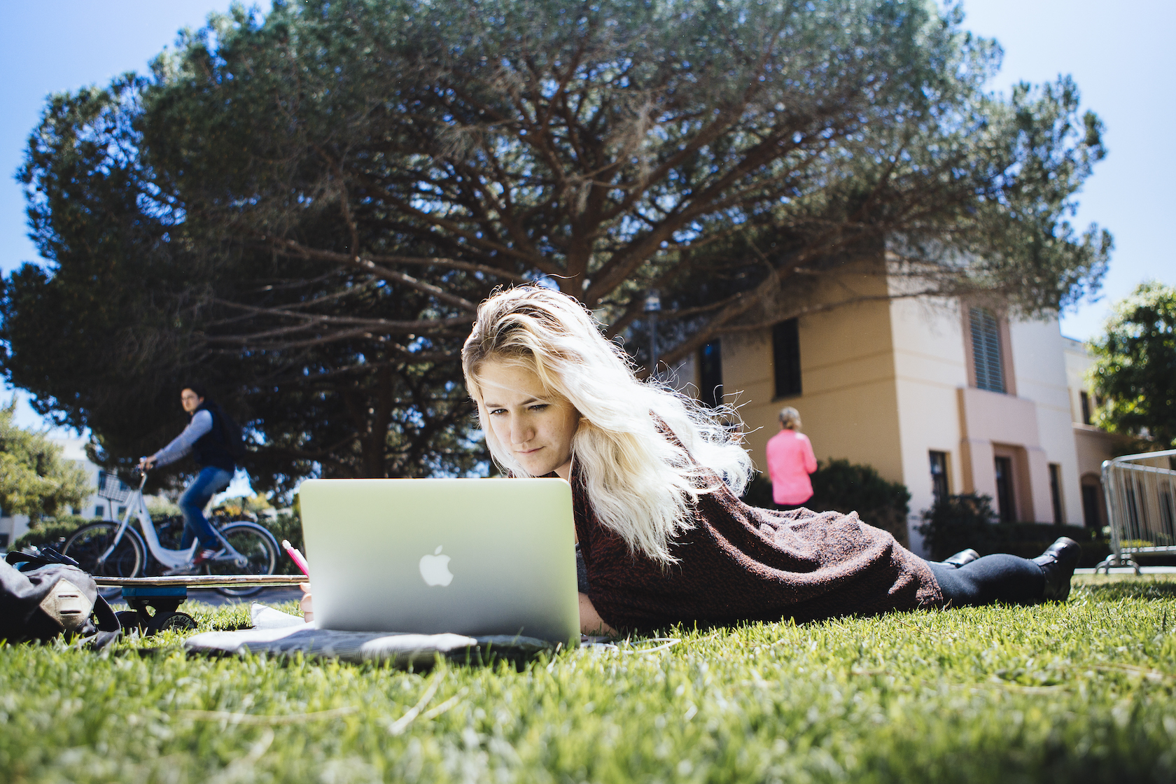 student relaxes on lawn at ucsb