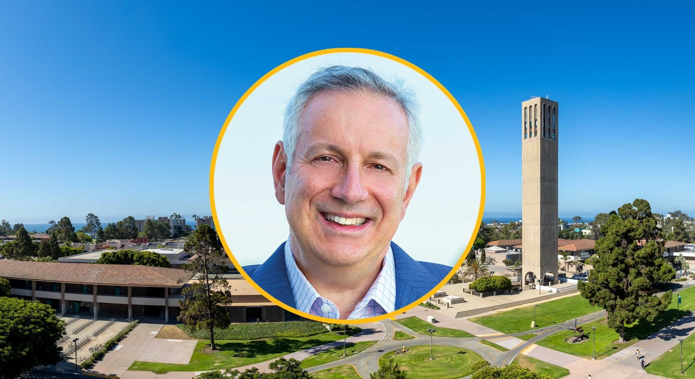 Photo of Dr. Dennis Assanis in front of a backdrop of the UC Santa Barbara campus.